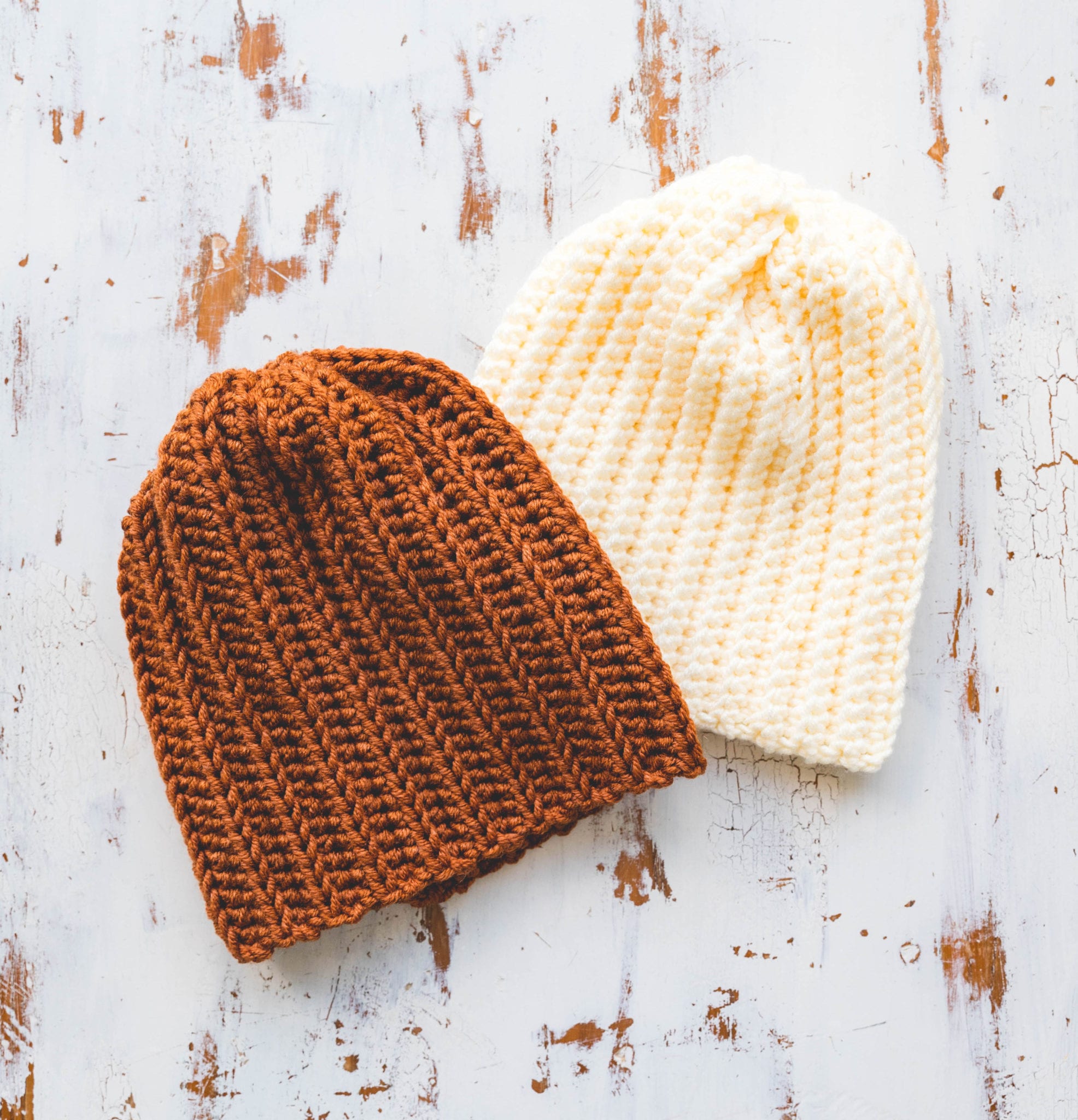 Two easy crochet hats in cream and kombucha bulky weight yarn.