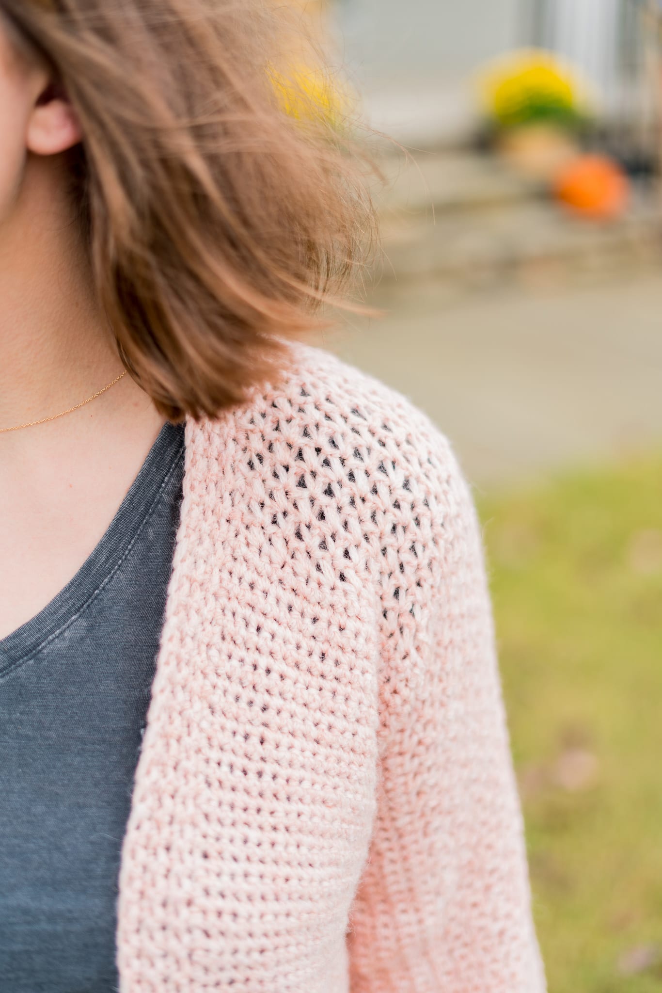 Easy crochet cardigan with lace detailing on the shoulder.